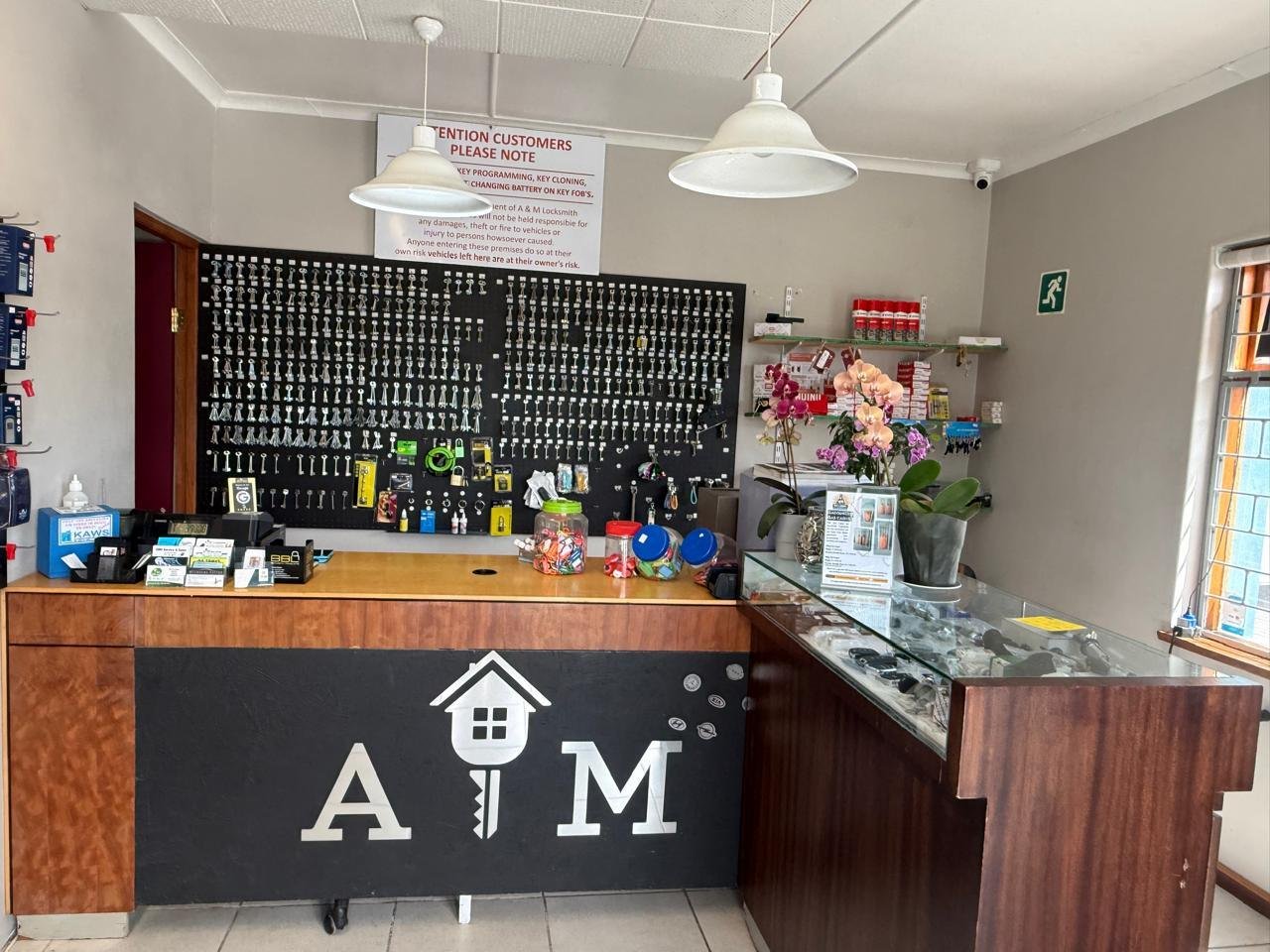 The front counter with the A & M logo and a wall of keys