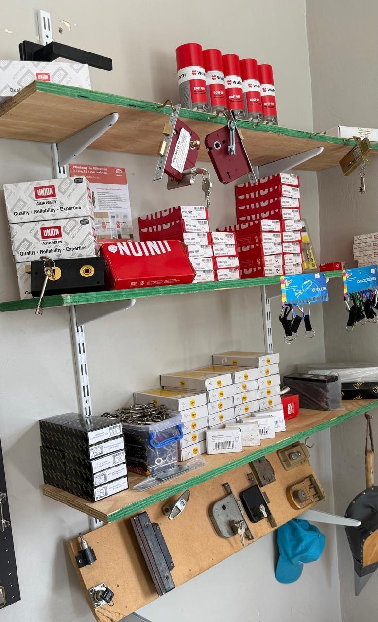 Shelves stacked with boxed Union and Yale locks, lock cases and key accessories